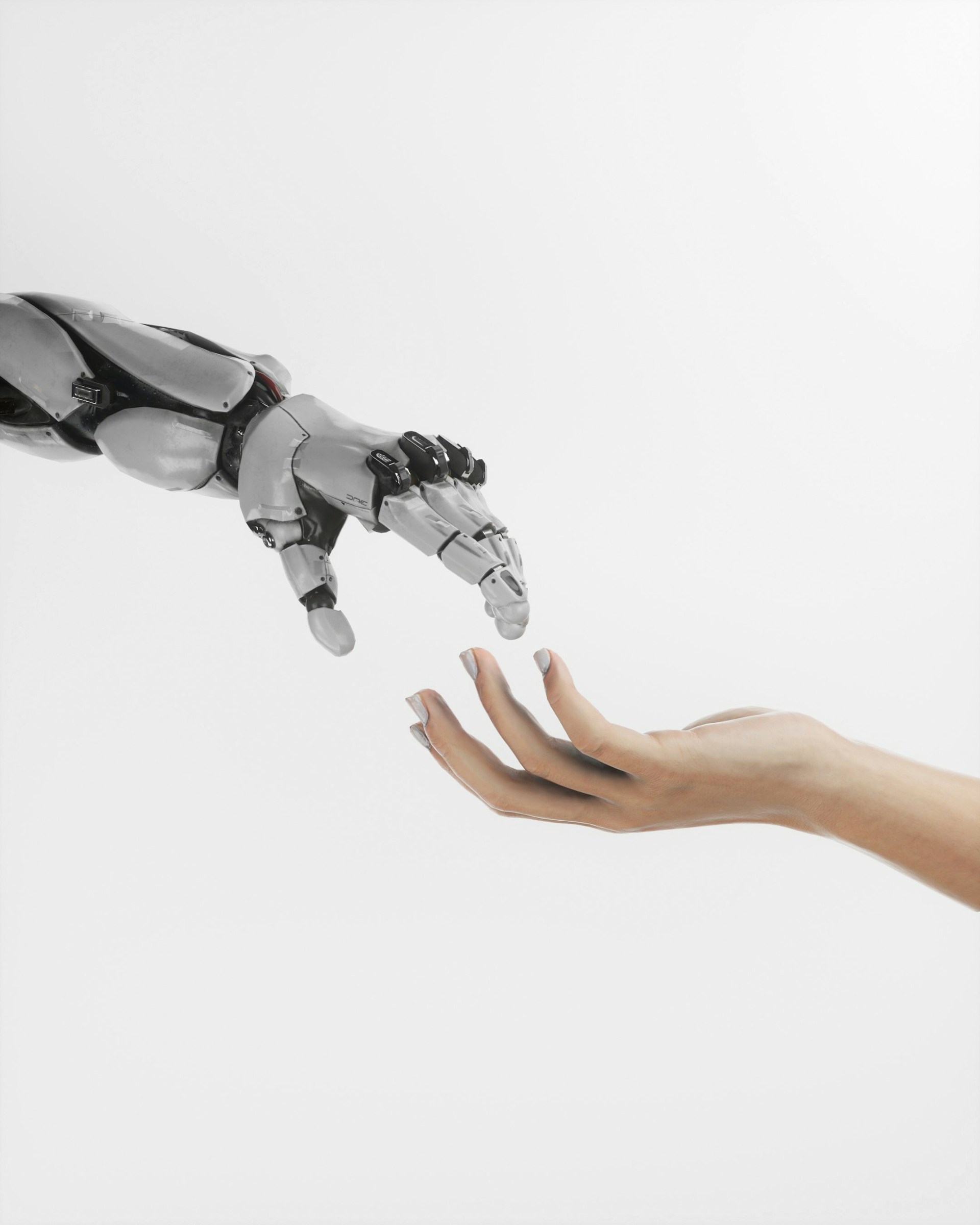 a human hand reaching out for a robotic hand.