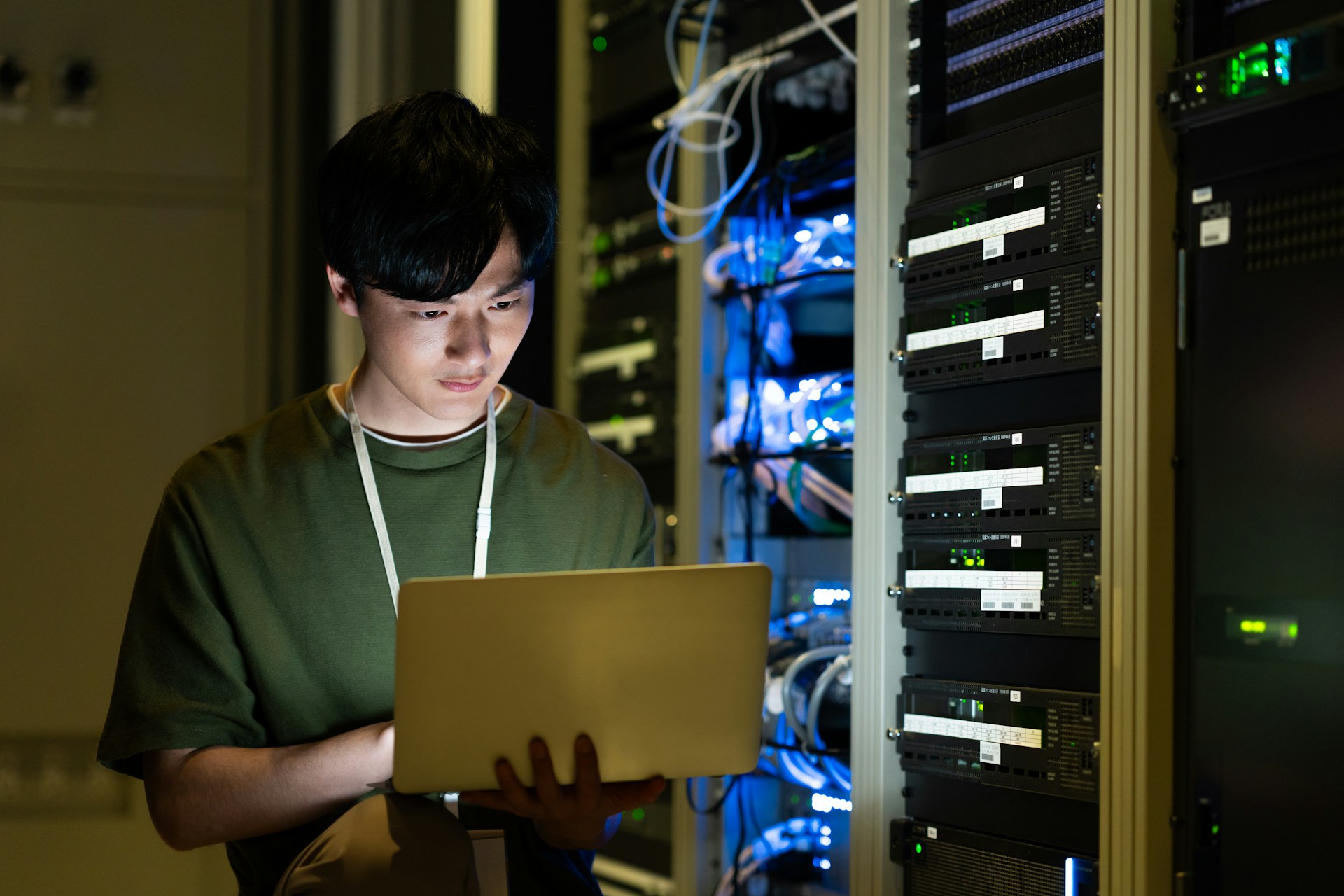 A young man starting up a bank of servers