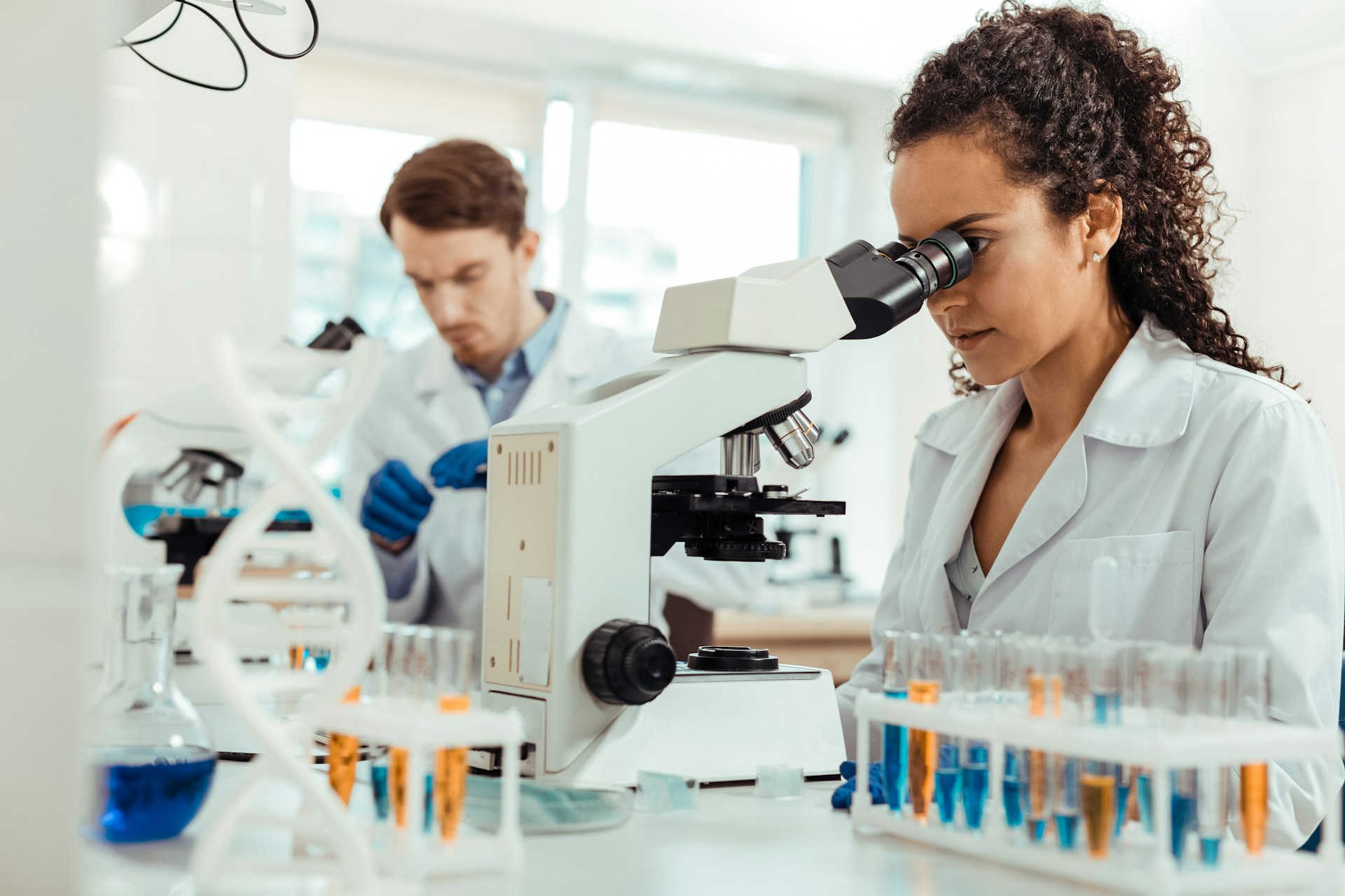 A scientist looking into a microscope